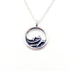 Silver necklace with a circular pendant that are waves