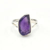 Silver ring with a large raw purple amethyst stone on a white background
