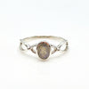 Silver ring with a labradorite gemstone on a white background