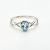Silver ring with a blue gemstone on a white background