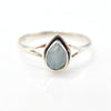 Silver ring with a teardrop-shaped aquamarine gemstone on a white background