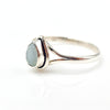 Silver ring with a light blue stone on a white background