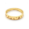 A gold band ring featuring engraved celestial symbols including stars, a crescent moon, and a sun.