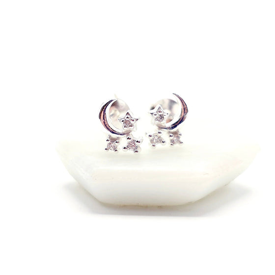 Silver earrings with star and moon designs 