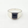 Silver signet ring with a black onyx square stone on a white background