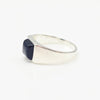 Silver ring with a black onyx stone on a white background