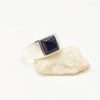 Ring with a black onyx gemstone on a white background
