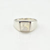 Silver ring with a square moonstone on a white background