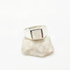 Silver moonstone wring on a textured white stone