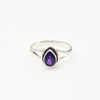 Silver ring with a purple amethyst gemstone on a white background