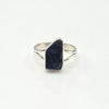 Silver ring with a raw black tourmaline stone on a white background