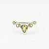Ring with green peridot gemstones on a white background
