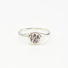 Silver oval signet Ring with engraved and oxidised wild flowers on a white background