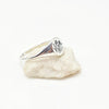 Silver ring with engraved wild flowers on a white stone background