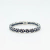 Silver ring with floral design on a white background