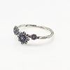 Silver ring with floral designs on a white background