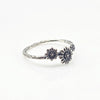 Silver ring with floral designs on a white background