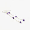 Purple teardrop earrings on a white background