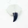 Black onyx blue animal tooth-shaped pendant on a white background