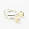 Silver hoop earrings with round lab opal charm