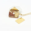 Envelope pendant with letter inside. Made of stainless steel availile in Gold and Silver. Part of the engravable collection