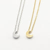 A minimalist high-polish stainless steel necklace featuring a dainty, solid crescent moon pendant on a delicate cable chain, Availble in Silver and Gold. Part of the Engravable Collection