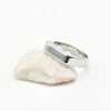 A polished silver-toned metal ring with a wide, flat, slightly tapered rectangular band, Made from Stainless Steel. Part of the engravable range