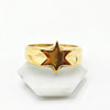 A gold ring with a polished star design.