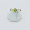 Silver ring with a green gemstone on a white background