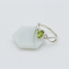 Silver ring with a green gemstone on a white background