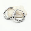 A pair of silver-toned huggie hoop earrings with textured, organic wavy edges and small bead details, Modern and chic everyda wear