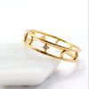 A gold openwork ring with moon and stars