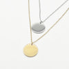 A minimalist high-polish stainless steel necklace featuring a blank 15mm round disk pendant