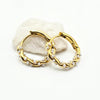 A pair of gold hoop earrings adorned with small white pearls, 