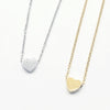 A minimalist high-polish stainless steel necklace featuring a dainty, solid heart pendant on a delicate cable chain,Availble in gold and silver. Part of the engravable range